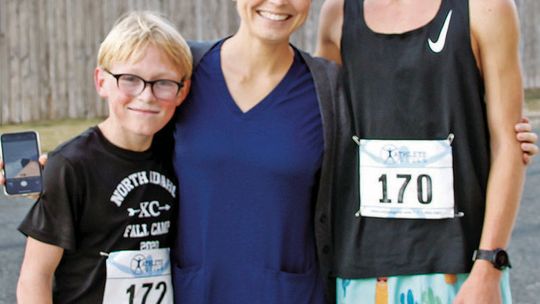 (From left) First-place winner Kingston Wilson, 13, with mom Joann Wilson, and second-place winner Keegan Wilson, 14, at the race.