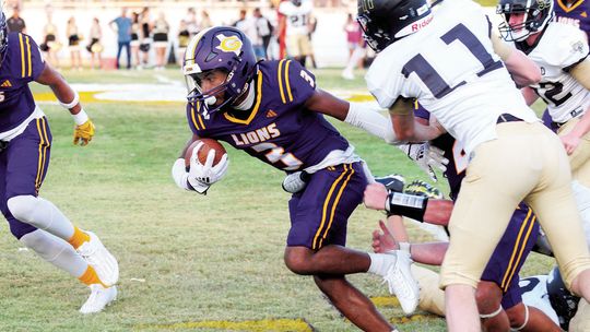 Granger High School varsity football senior running back Jayven Diaz breaks a tackle and runs for extra yardage on Aug. 25 during the Lions’ 57-8 blowout victory at home vs. Hubbard High School. Photo by Larry Pelchat