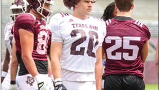 Johnny Ryder watching the drill, waiting his turn while living his dream in an Aggie uniform. Photos Michelle Messex