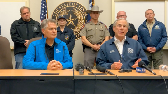 Gov. Greg Abbott (right) and Williamson County Judge Bill Gravell hold a press conference Monday, March 21, to update the community after storms in the county. Precinct 4 Commissioner Russ Boles (back, left) is also shown. Facebook / Williamson County Emergency Services