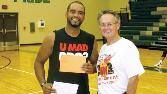 Adam Graves (left) was awarded his prizes by former Taylor Press Publisher Dennis Wade after winning both the three-point and free-throw contest on July 21, 2013, at the first-ever Taylor Press 3-on-3 Basketball Tournament. Photo by Jason Hennington