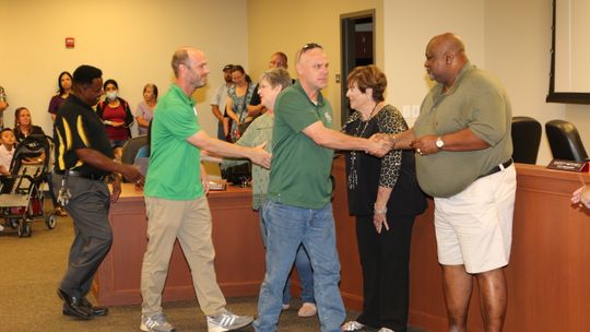 Carl Caldwell (left), soccer coach John Brockway (middle) and Dan Dixon are greeted with thanks and appreciation from the Taylor School Board for their quick actions and efforts in keeping the boys soccer team safe in their travels to a recent game. Photo by Tim Crow