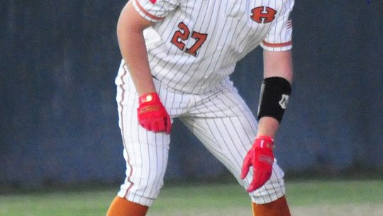 Carson Forrest taking a lead off of third base contemplating stealing home.