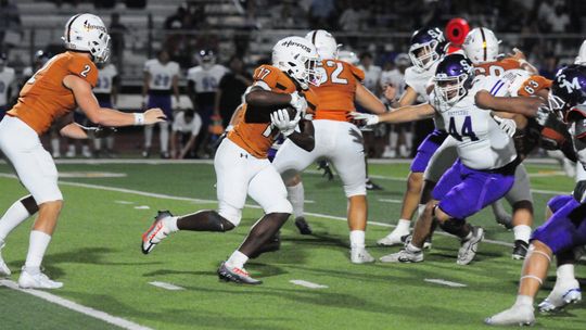 Hutto High School varsity football sophomore running back Keilan Chavies (17) takes a handoff from senior quarterback Will Hammond (2) on Aug. 25 during the Hippos’ 66-35 victory at home vs. San Marcos High School. Photo by Larry Pelchat