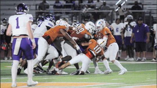 Hutto High School varsity football senior linebacker Israel Medrano (10) and a swarm of his teammates make a tackle on Aug. 25 during the Hippos’ dominant 66-35 victory at home vs. San Marcos High School. Photo by Larry Pelchat