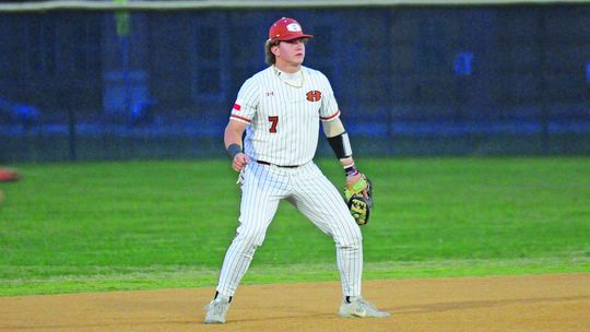 Garet Boehm getting into his defensive stance as the pitch is delivered. Photos by Larry Pelchat