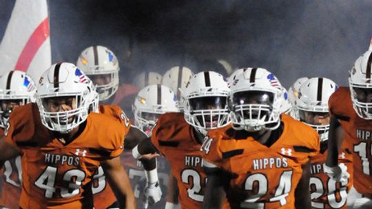 Hippos varsity football runs out of the tunnel on Friday night prior to Hutto’s dominant 66-35 victory at home against San Marcos. Photo by Larry Pelchet