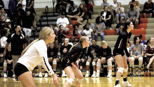 Hippos’ senior Adriana Gonzalez (left) gets in her defensive set along with Macie Atkinson (middle) and Isabella Orton. Photo by Evan Hale