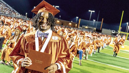 Jacob Bass smiles after he receives his diploma and his classmates line up to walk the stage. Photos courtesy of Hutto ISD Facebook page