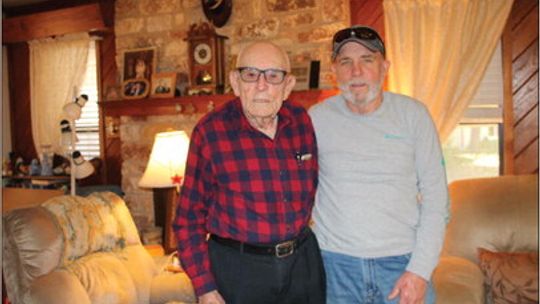 World War II veteran Archie Moczygemba with his son Bill at the elder’s home in Taylor. Photos by Nicole Lessin