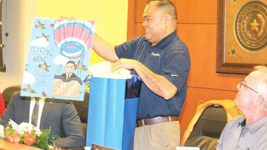 Taylor ISD school board president Marco Ortiz is presented with a personalized work of art from Legacy Early College High School during the school board meeting Jan. 24 in honor of his dedication and commitment to the Taylor schools. Photos by Tim Crow