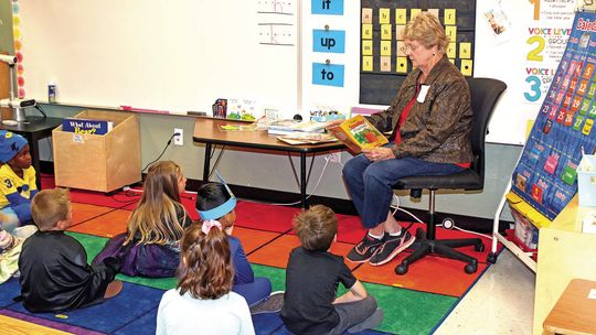 Retired Taylor teacher Kay Hortenstine reads a story to kindergarten students taught by her granddaughter, Lauren Hortenstine Jaecks. Hortenstine taught third grade for many years at T. H. Johnson Elementary and later at Pasemann. Photo by Tim Crow