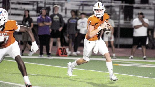 Hutto High School varsity football senior quarterback Will Hammond rolls out to his left and looks for an open receiver on Aug. 25 during the Hippos’ blowout 66-35 victory at home vs. San Marcos High School. Photo by Larry Pelchat