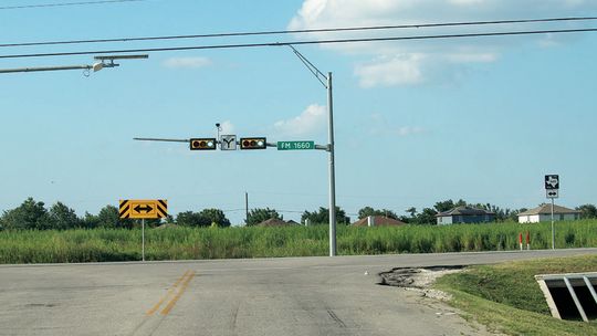 Existing three-way intersection at FM 1660 and CR 137. The field shown is slated to become a residential subdivision using CR 137 as an entrance, creating a fourway intersection. Photo by Edie Zuvanich