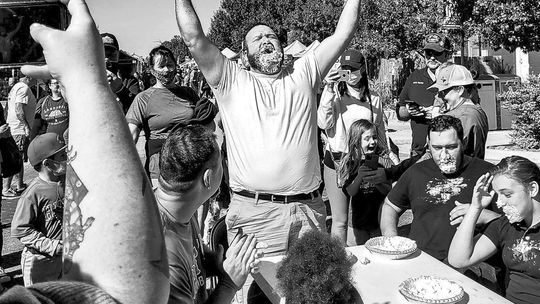 Contestants dive into pies face first to win the pie eating contest. Facebook/Hutto Chamber