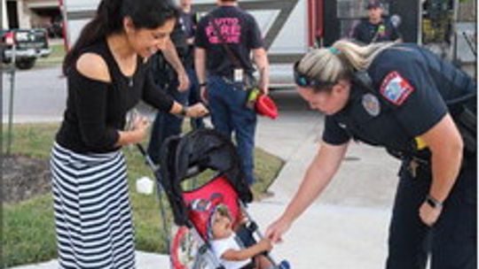 Hutto police department focuses on building community relationships. Esmeralda Solis looks on as baby Zay is entranced by officer Jamie Alcocer during the National Night Out event Oct. 4, 2022. File Photo by Edie Zuvanich