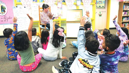 Students in Julie Snyder’s class happily listen and participate with the lesson on the book, “The Bug Cemetery.” Photos by Ryan Newsom