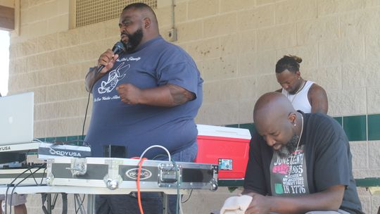 Quincy Sharp (left) leads in prayer during a Juneteenth celebration at Fannie Robinson Park in Taylor June 19, 2022. Photo by Fernando Castro