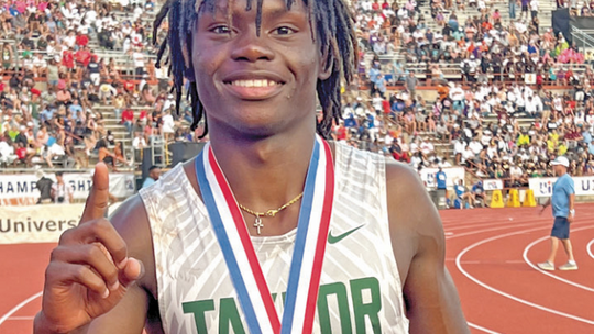 Ducks star Jarvis Anderson proudly shows off his gold medal after winning the 300-meter hurdles event on May 11 at the UIL Track and Field Championships held at Mike A. Myers Stadium in Austin. Photo by Briley Mitchell