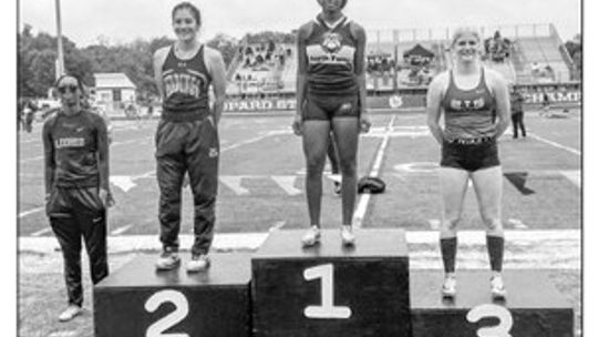 Emma Whitsel standing on the podium after earning third place in the 100-meeter hurdles. Courtesy photo