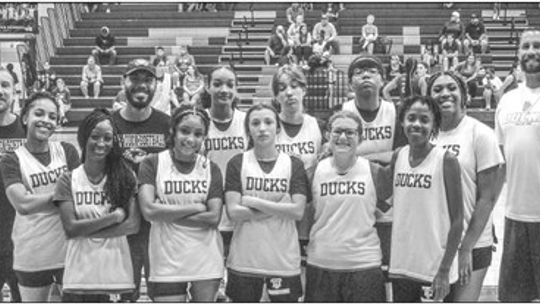 The Taylor High School girls’ varsity basketball team and Lady Ducks’ coaches gather on Tuesday, June 13 prior to a scrimmage at home vs. Bastrop High School. Photo by Andrew Salmi