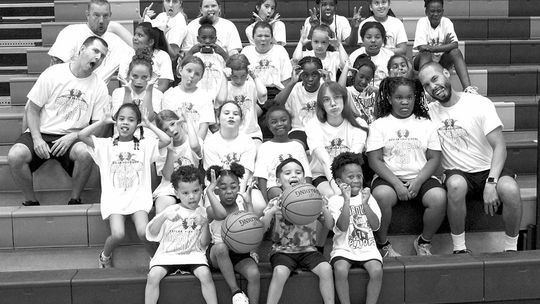 Taylor campers and coaches from grades two through five make silly faces on June 8 following the final day of Lady Ducks Youth Basketball Camp.