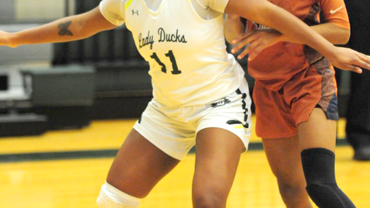 Lady Ducks senior Aliyana Chavis boxing out Caldwell senior guard Jae Mathis before grabbing a rebound. Photo by Larry Pelchat