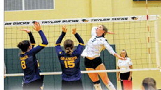 Taylor High School varsity volleyball junior Haley Harms powerfully spikes the ball on Aug. 22 during the Lady Ducks’ home match victory vs. Granger High School. Photo by Larry Pelchat