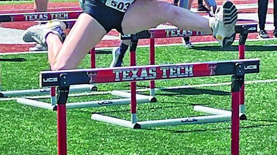 Lady Ducks senior Emma Whitsel jumping over a hurdle during her race on her way to second place. Courtesy Photo