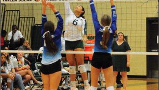 Taylor High School varsity volleyball sophomore Elena Martinez goes up high to get her hand on a ball at the net on Sept. 1 during the Lady Ducks’ match victory at home vs. rival Rockdale High School. Photo by Larry Pelchat