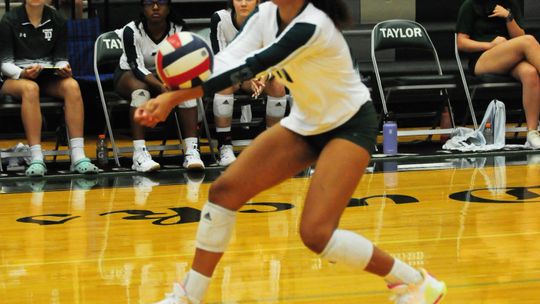 Taylor varsity volleyball senior Hannah Wamble digs the ball on Tuesday night during the Lady Ducks' home win against Lampasas. Photo by Larry Pelchat.