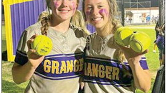 Abi Crouch (left) and Mattie Wilkie posing with their home runs balls after a win. Courtesy Photo