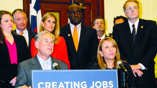 Gov. Greg Abbott and Senate Finance Committee Chair Joan Huffman discuss the proposed Texas Creating Helpful Incentives to Produce Semiconductors Act March 15 at the Capitol. Photo by Nicole Lessin