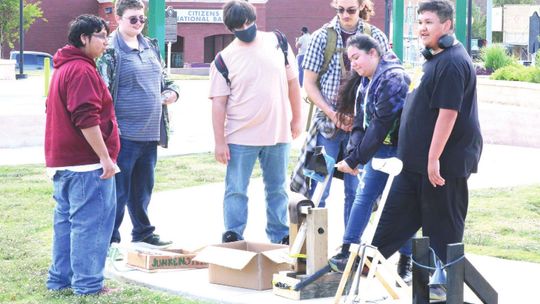 Students from physics classes and robotics classes at Legacy Early College High School team up to launch the catapults they designed and built to learn about projectile motion. Photo by Tim Crow