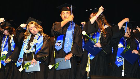 Legacy graduates move their tassels from right to left after receiving diplomas. Photo by Tim Crow