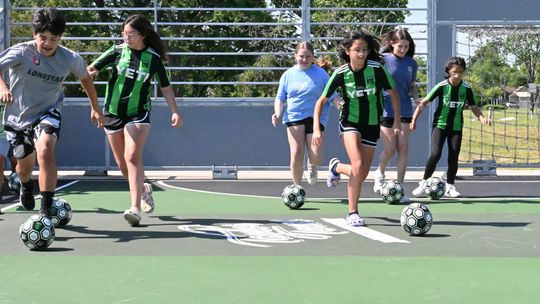 Children kick off use of the new soccer mini-pitch Saturday morning. The court can be used for individual and pickup soccer games. Photos by Kendra Maness