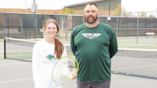 Taylor High School’s Regional Tennis Champ, Rylee Michna, and her coach, Kevin Williams, take a break during practice. Photo by Tim Crow