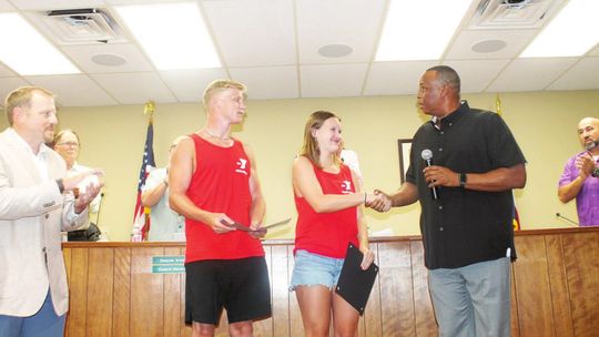 Mayor Gerald Anderson shakes lifeguard Sydney Branson’s hand prior to doing the same with Landon Mikulencak as Taylor parks and recreation director Tyler Bybee (far left) and the Taylor City Council look on during a meeting at city hall in Taylor June 23. Photo by Fernando Castro