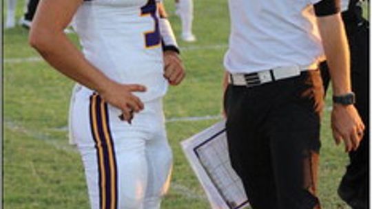 Granger High School varsity football senior quarterback Chase Edwards (5) talks with head coach Stephen Brosch on Sept. 8 during the Lions’ road game against Holland High School. Photo by Elliot Bohuslav