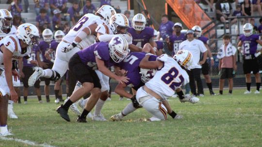 Granger High School varsity football senior outside line backer Thomas Youngblood (82) brings down an opposing ball carrier for a loss of yardage on Friday, Sept. 8 during the Lions’ road game at Holland High School. Photo by Andrew Salmi