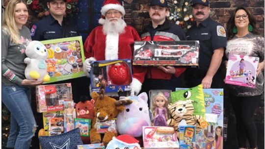 Toys were collected by Rena Unique Photography for the Red Santa program. At the presentation to the fire department were (from left) Rena Wade, Cody Kraemer, Santa, Aaron Harralson, Zach Reeves and Briana Ford.