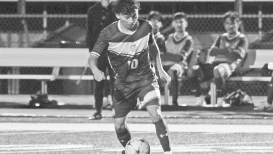 Ducks senior Ivan Aguilar dribbling the ball has defenders close in on him. Photo by Evan Hale