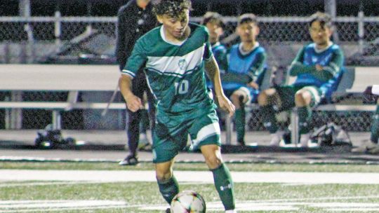 Ducks senior Ivan Aguilar dribbling the ball has defenders close in on him. Photo by Evan Hale