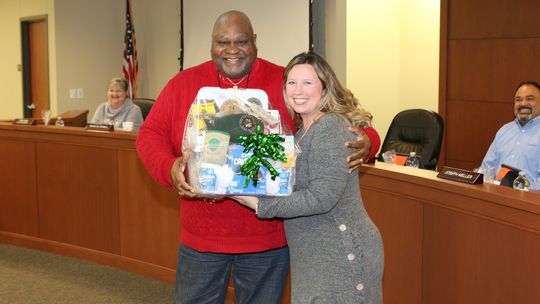 Main Street Intermediate School Principal, Kerri Pierce, presents a gift basket of appreciation to Taylor ISD School Board Member, Shorty Mitchell. Photos by Tim Crow