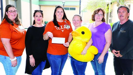 Representatives from the new nonprofit, Mama Duck, present a check to representatives from Taylor ISD Child Nutrition to clear all current student lunch debt. From left are child nutrition personnel Holly O’Briant, Angelica Cazalas, Lindsey Gage, and Mama Duck representatives Desiree Grady...