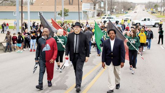 Led by (from left) Rev. Brian Coleman, Rev. Anthony Watson and Rev. Carl Caldwell, the Martin Luther King Jr. march proceeds over the Main Street overpass. Photo by Jason Hennington