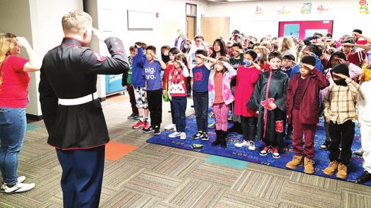 Lance Corporal Noah Goertz does a shared salute with students at the Howard Norman Elementary School during his visit last week. Photos courtesy of the Hutto ISD Facebook page