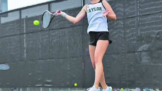 Lady Duck freshman tennis player Rylee Michna strikes the ball on her way to a state championship. Photo by Krista Randig