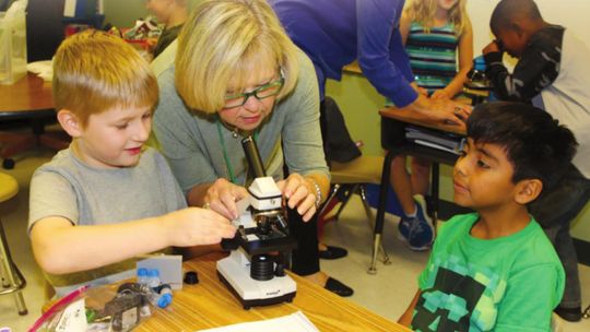 A career of giving back Moppy Miller joins a second grade class at Naomi Pasemann Elementary School in Taylor in 2016 for their first lesson with microscopes, a project that was funded by a TEE Foundation grant. Photos by Tim Crow