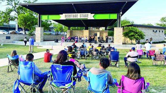 Oasis Church Pastor Mary Flores speaks over the crowd at Heritage square for a community honoring of the National Day of Prayer May 4. Photos by Grace Horvath